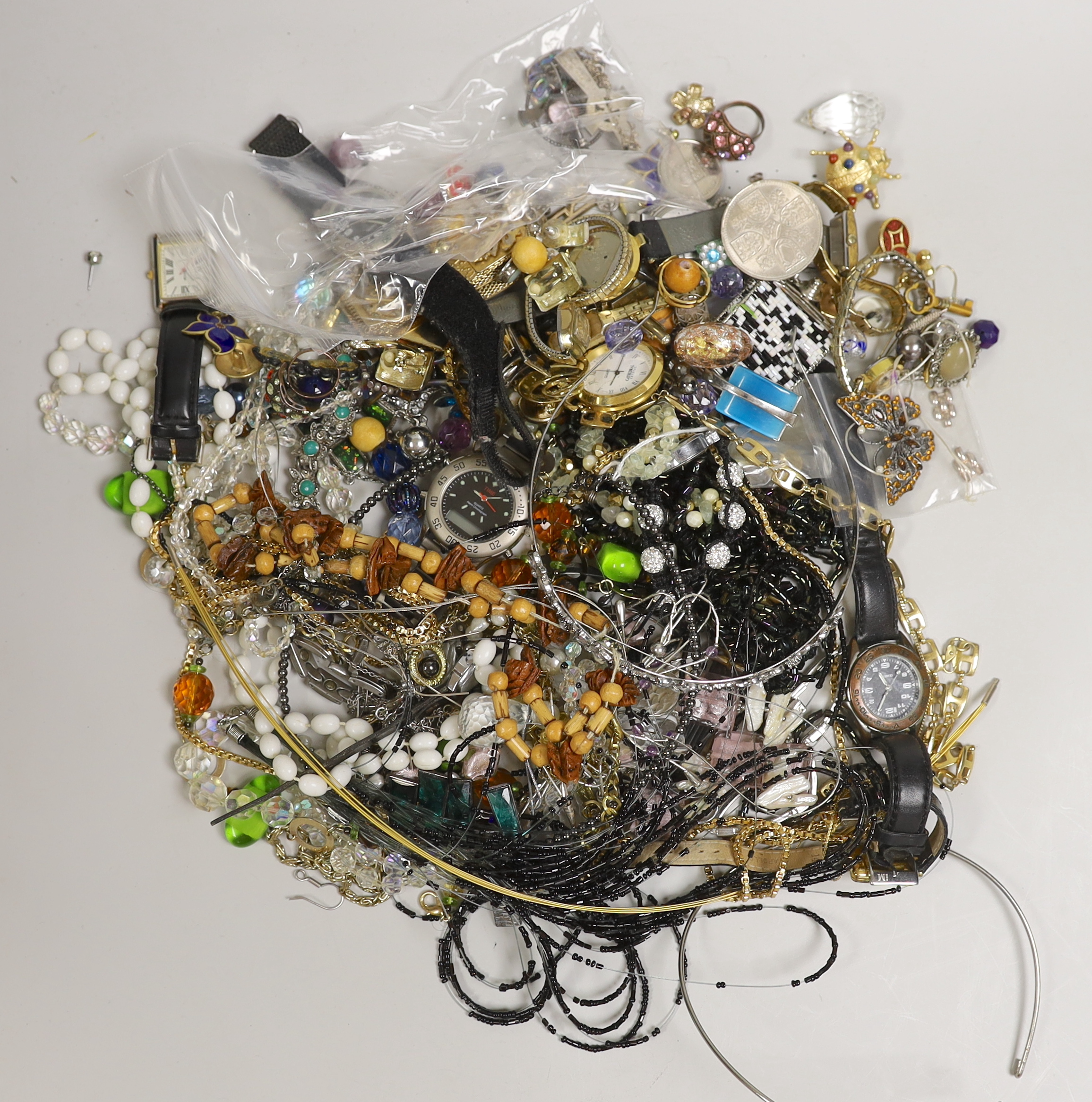 A box of costume jewellery including silver brooches and pendants.